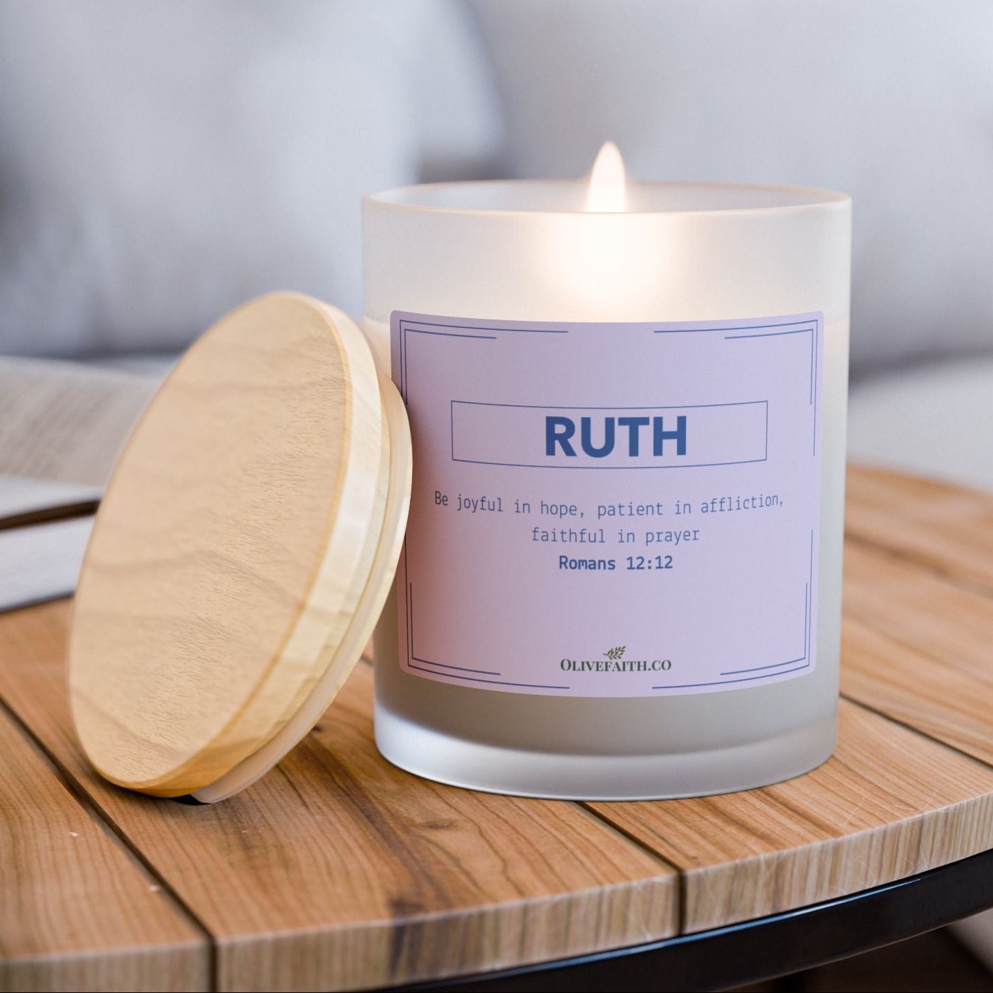 Personalized 11oz frosted glass candle with wooden lid, featuring the Bible verse “Be joyful in hope, patient in affliction, faithful in prayer” and a custom name in a muted lavender style – Olive Faith Christian gift.