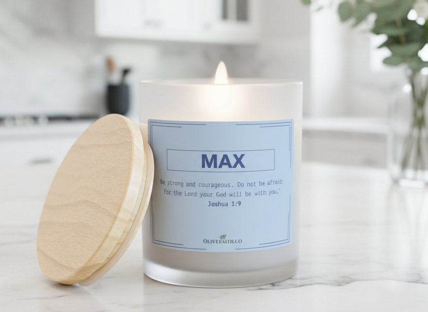“Be strong and courageous personalized Christian candle. Do not be afraid; for the Lord your God will be with you. – Joshua 1:9” in soft blue font, displayed on a marble countertop in a bright, modern kitchen with greenery and natural daylight – Christian gift by Olive Faith.